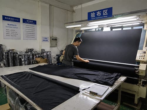 Incoming fabric inspection before bulk cutting at outdoor jacket OEM factory Incoming fabric inspection before bulk cutting at outdoor jacket OEM factory