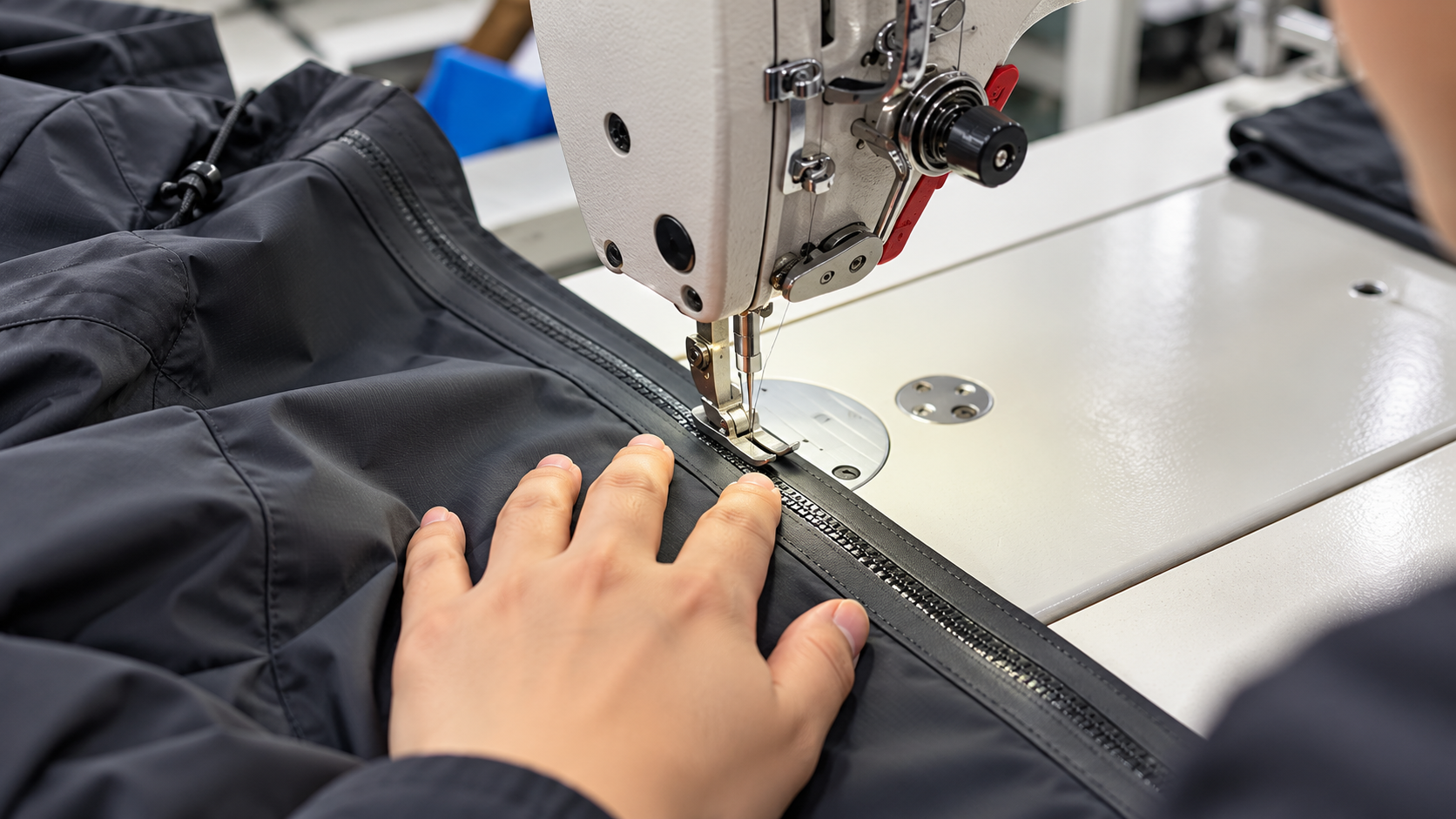 Industrial sewing of a waterproof zipper onto technical jacket fabric